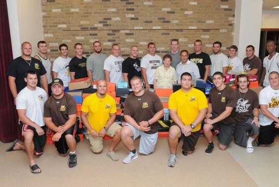 Football Team Begins Camp By Giving "School Supplies to Needy Kids"