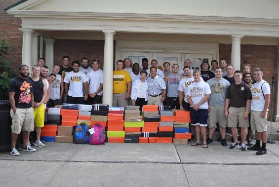 Senior members of the BW football team join Head Coach John Snell and Church Street Ministry Director Frannie Milward with the school supplies provided by the whole team.